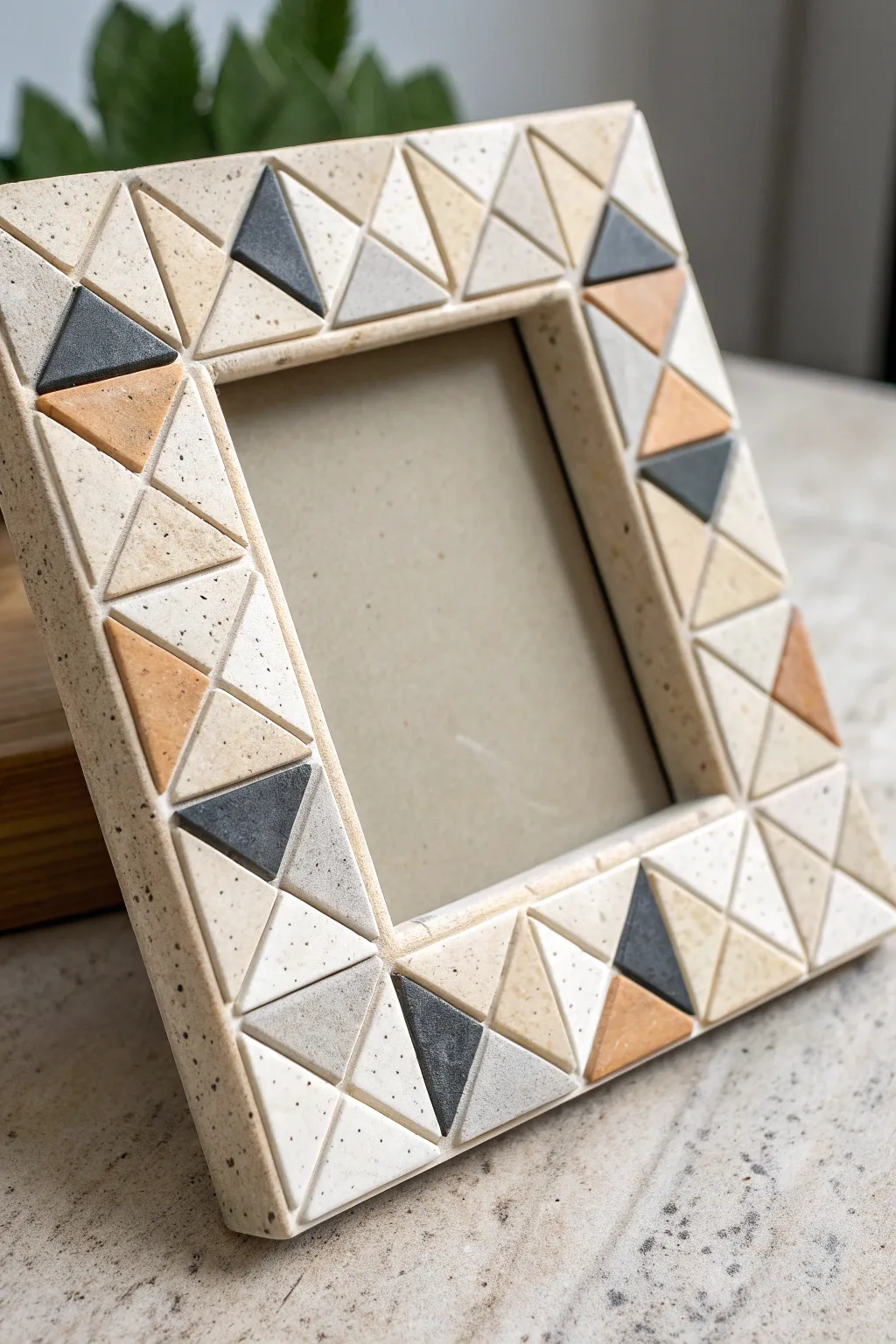 Minimal geometric clay tile frame in soft neutrals with charcoal accents for crisp contrast