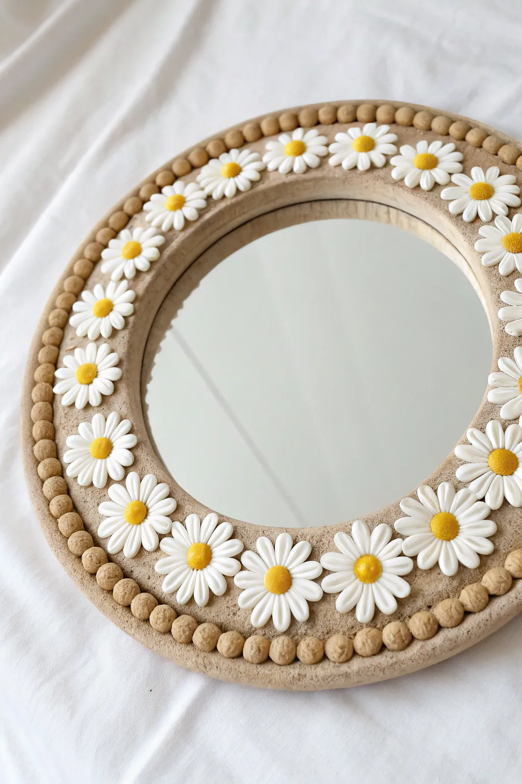 DIY clay mirror with daisy chain border and tiny spacer dots for soft Scandinavian boho charm.