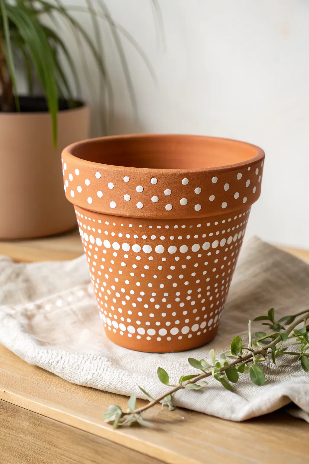 Simple white dot stencils on terracotta for an easy, modern pot with handmade charm