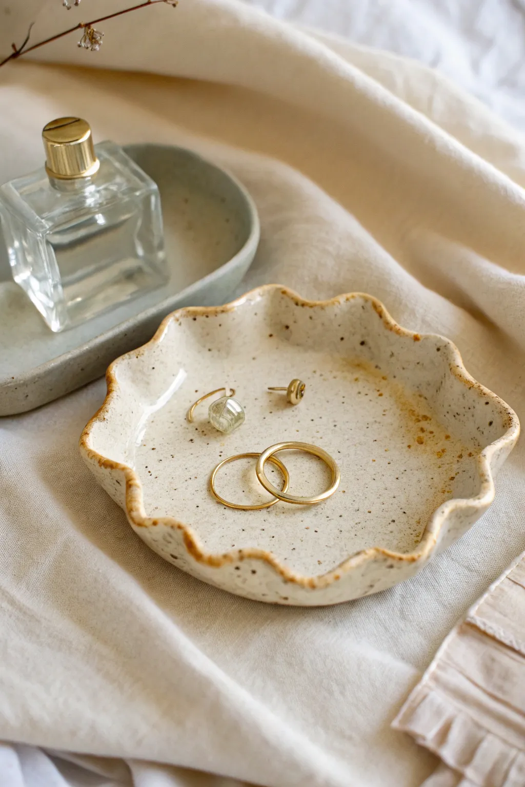 Creamy wavy edge trinket tray with subtle handmade texture, styled simply with earrings