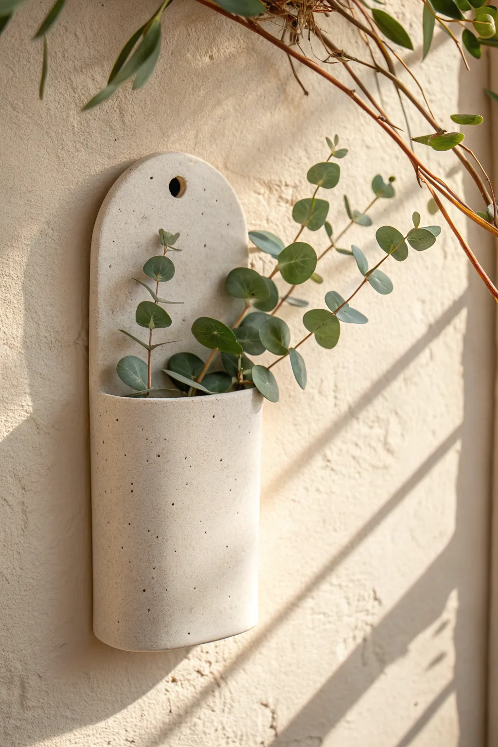 Minimalist clay wall pocket with rounded top and eucalyptus, clean Scandinavian boho style