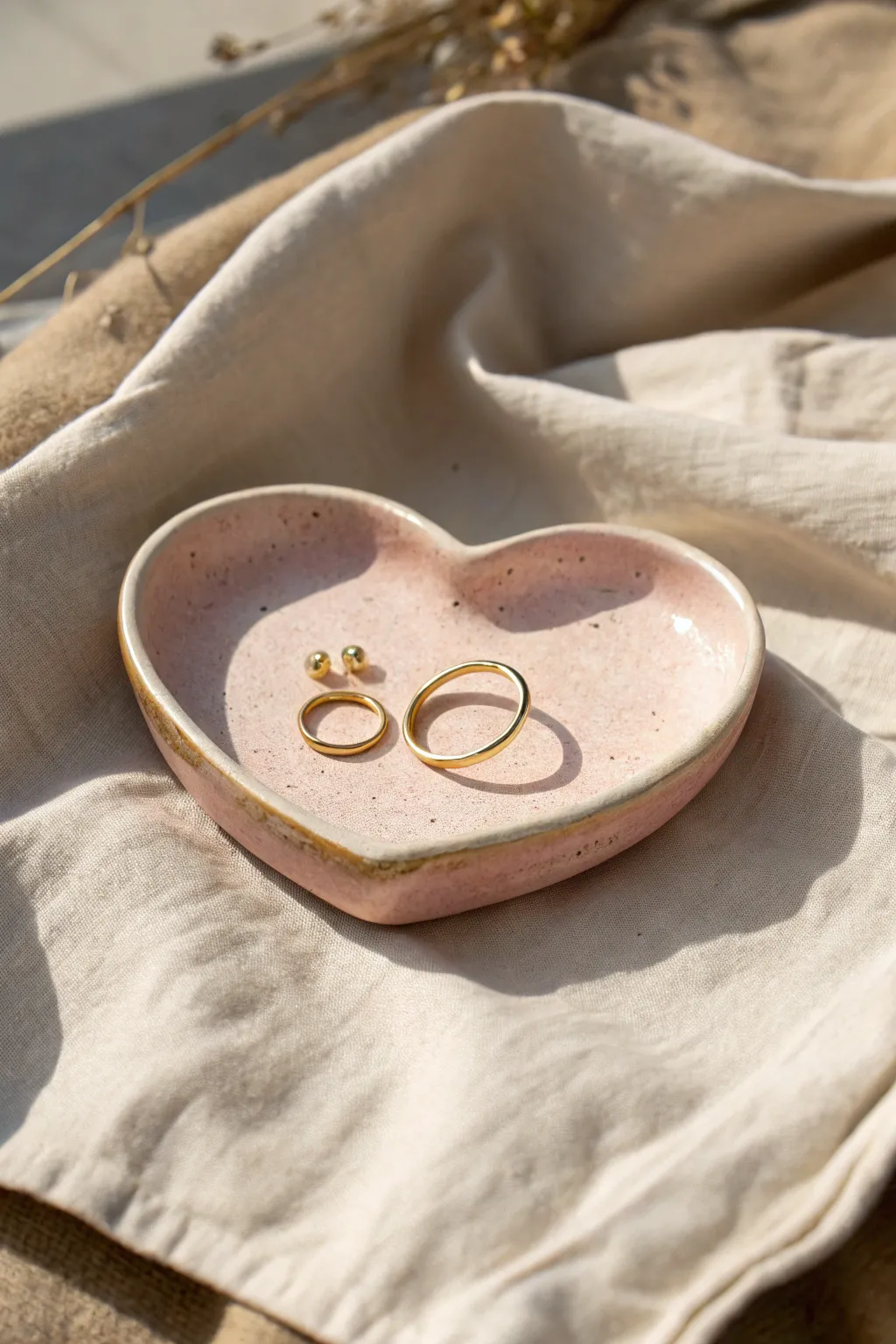 Blush heart trinket dish for rings and studs, styled on linen in soft minimalist light