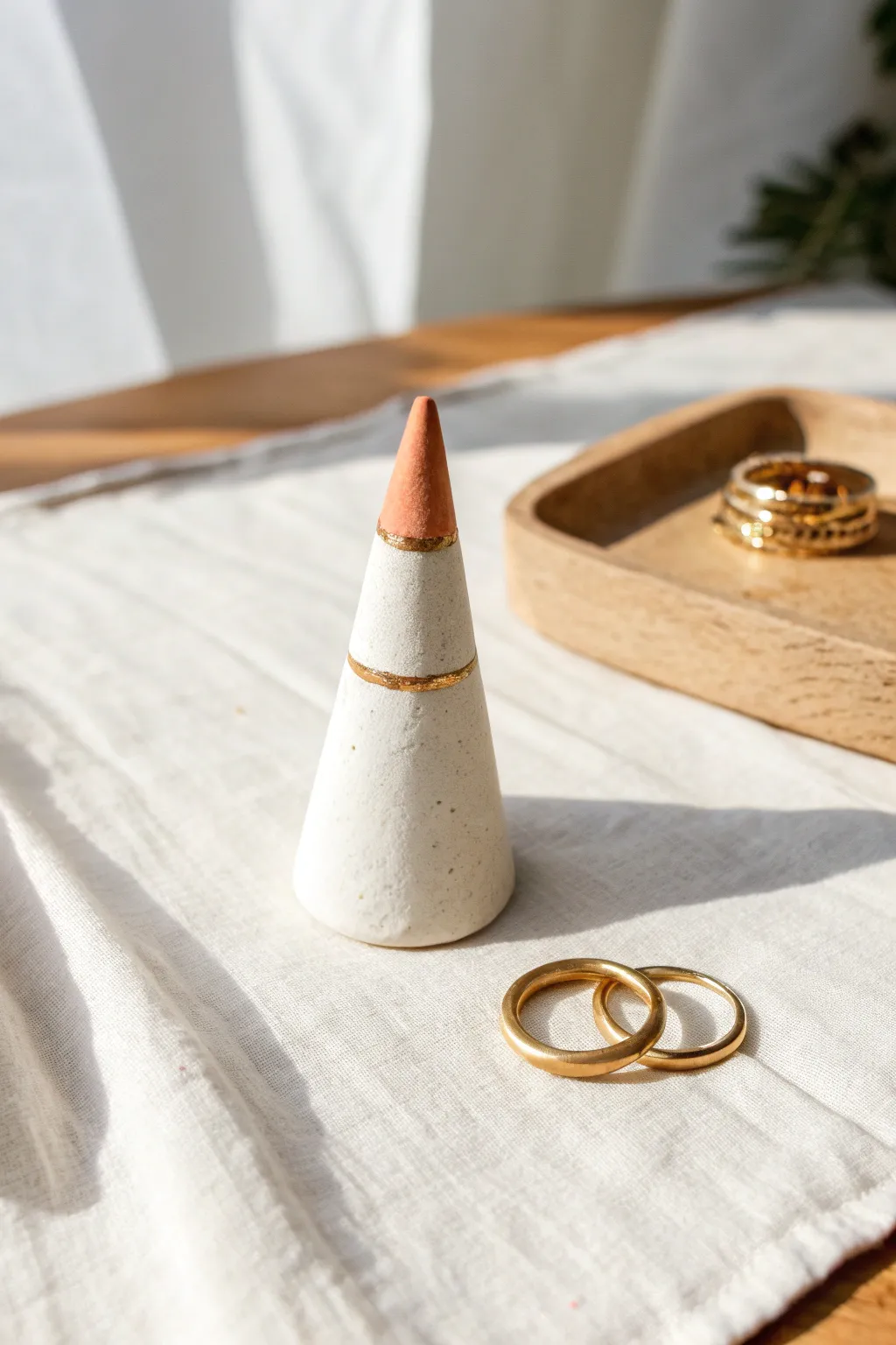 Simple air-dry clay ring cone with a painted tip, minimalist styling and soft natural light.