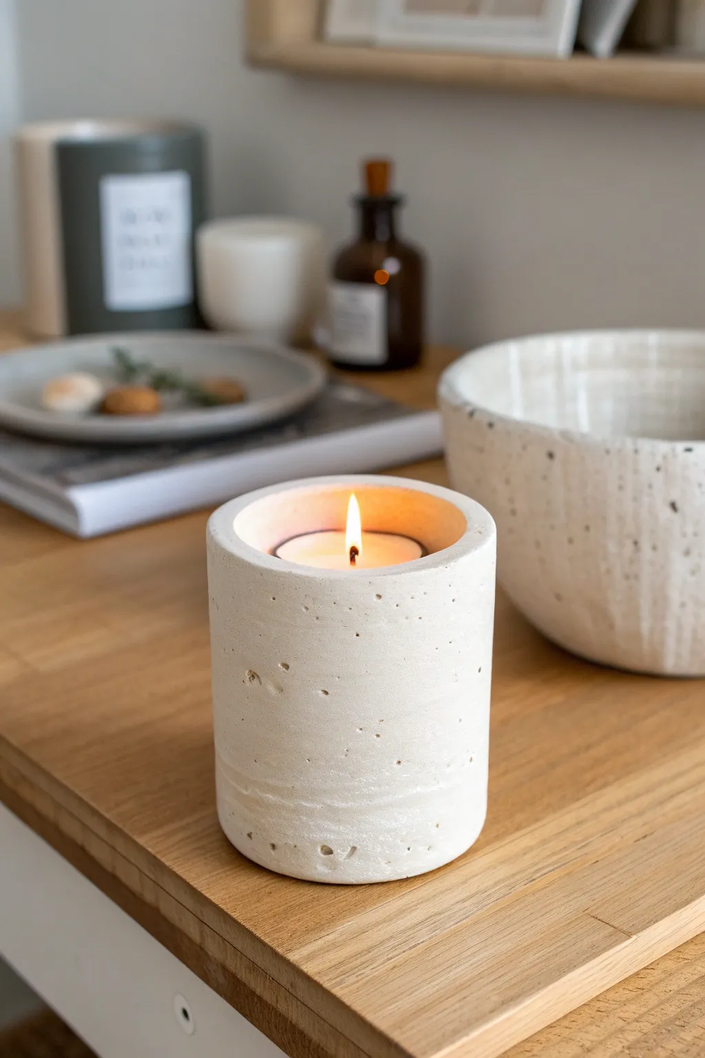 Off-white clay cylinder votive holder glowing warmly, minimalist and handmade for cozy calm.