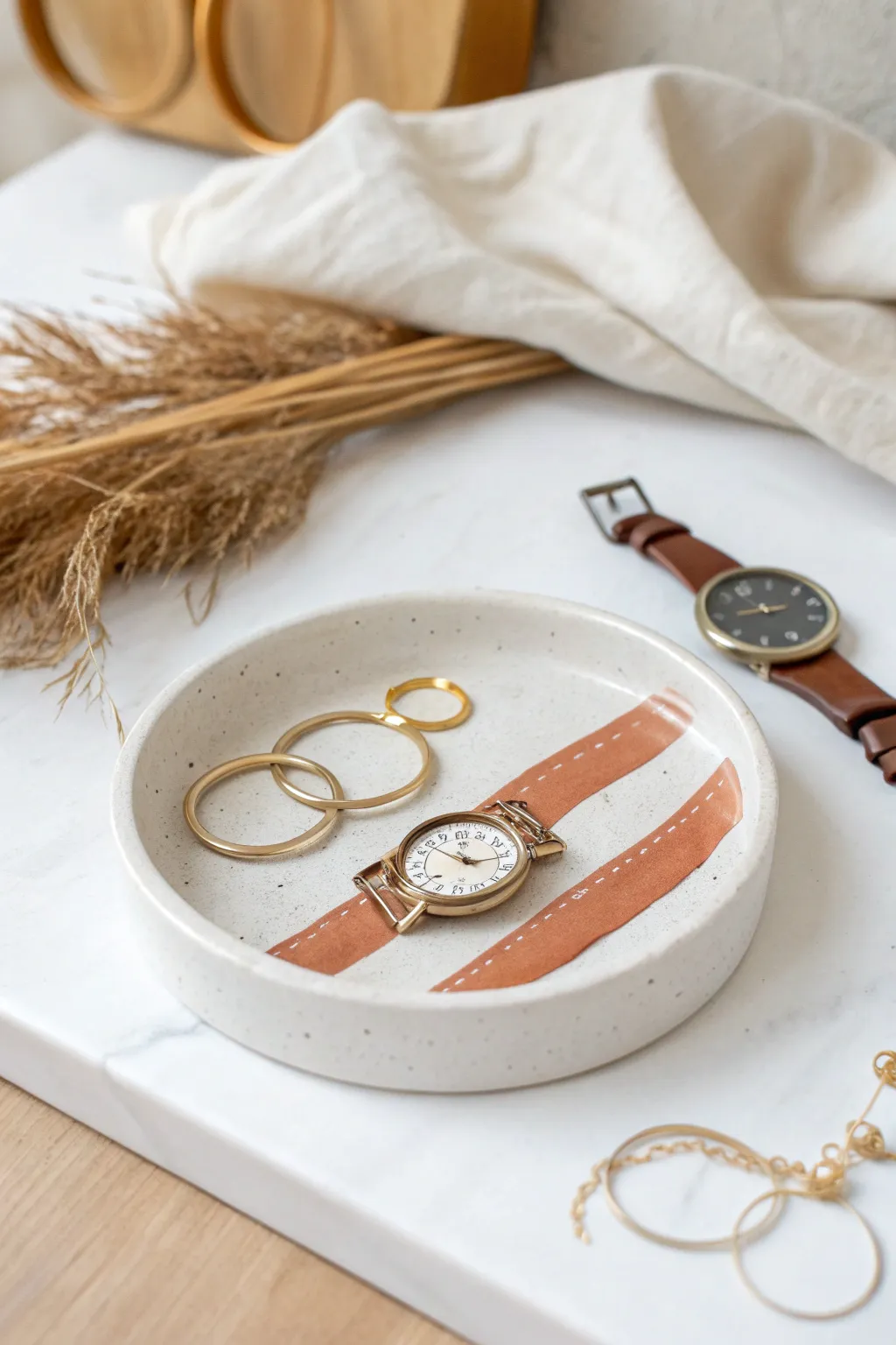 Minimalist air dry clay catchall tray to keep earrings and a watch beautifully organized
