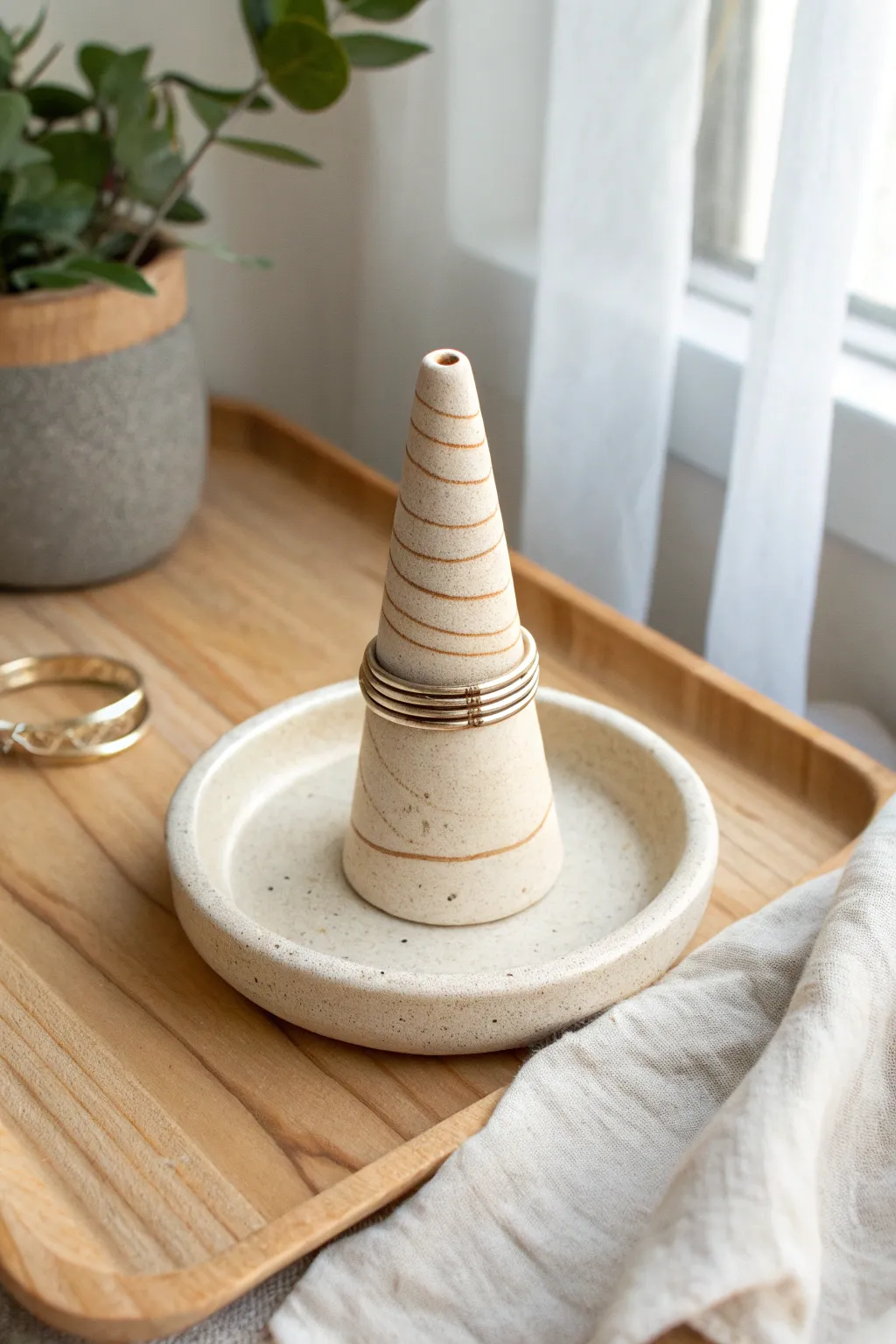 Minimal coil ring holder cone in warm matte clay, a simple sculpting win for beginners