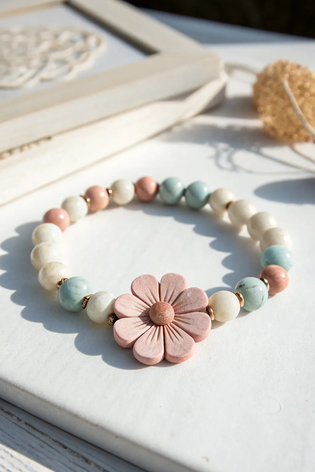 Pearl accents make the flower bead pop, framed by pastel clay discs for a fresh minimal look.