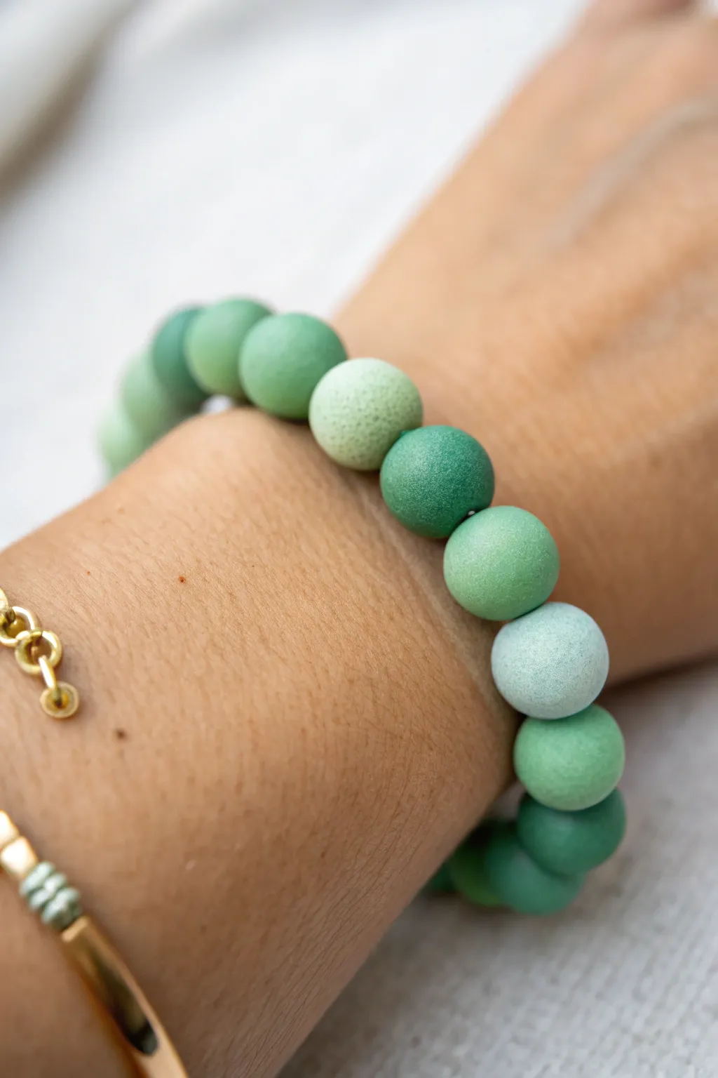 Mint-to-emerald ombre clay bead bracelet, minimal and boho, shown on-wrist for a clear gradient