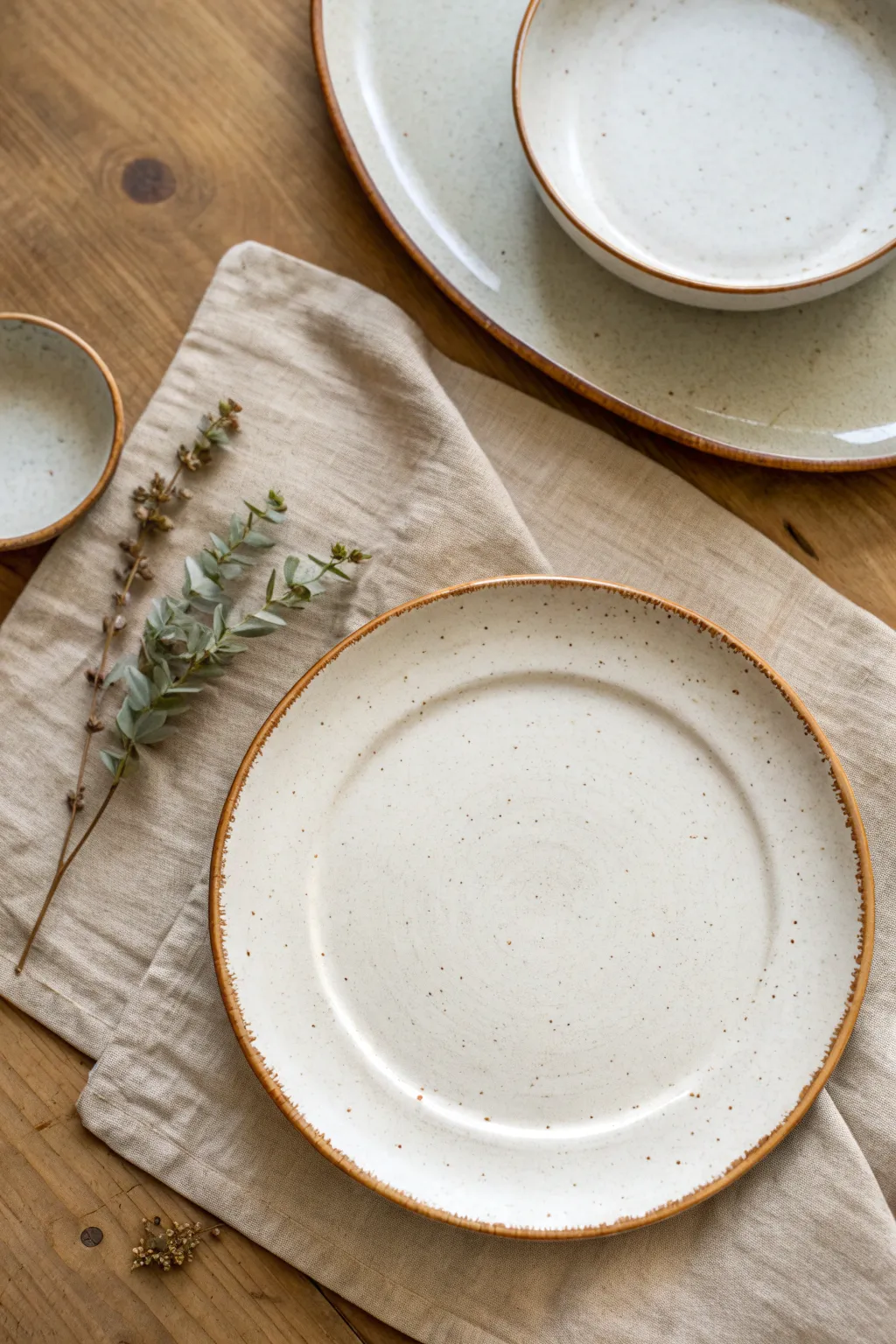 Soft-rim slab plates in satin white glaze, minimalist handmade charm for everyday tables.