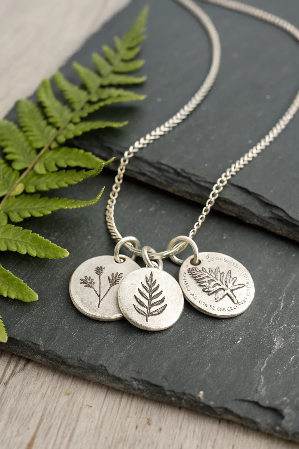 Fern frond charm necklace in silver metal clay, minimalist botanicals with soft boho styling.