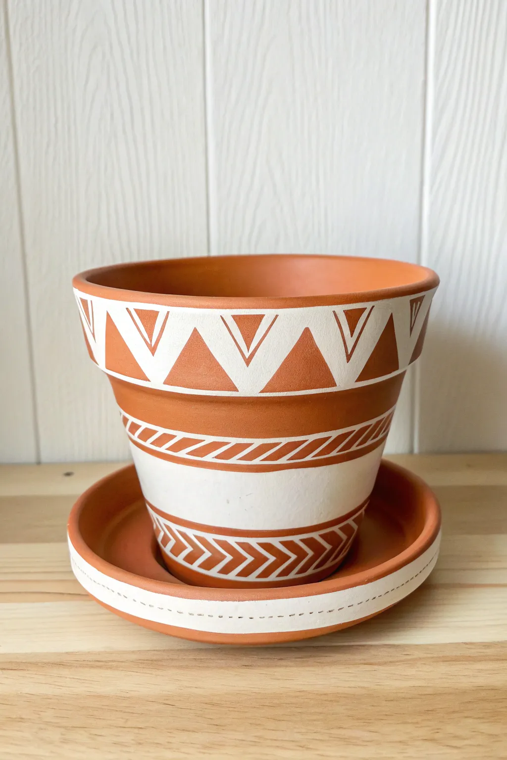 Crisp tape-made stripes on a mini clay pot for an easy Scandinavian-boho shelf accent.