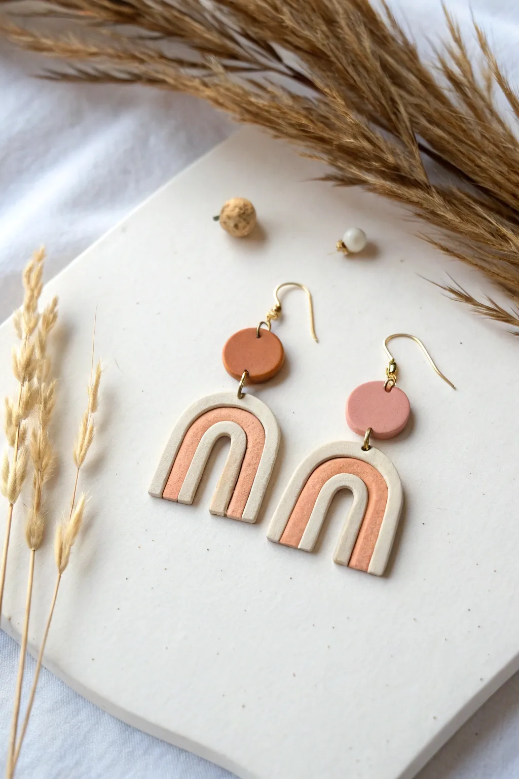 Simple geometric oven-bake clay earrings in soft neutrals, modern shapes, and clean minimal styling.