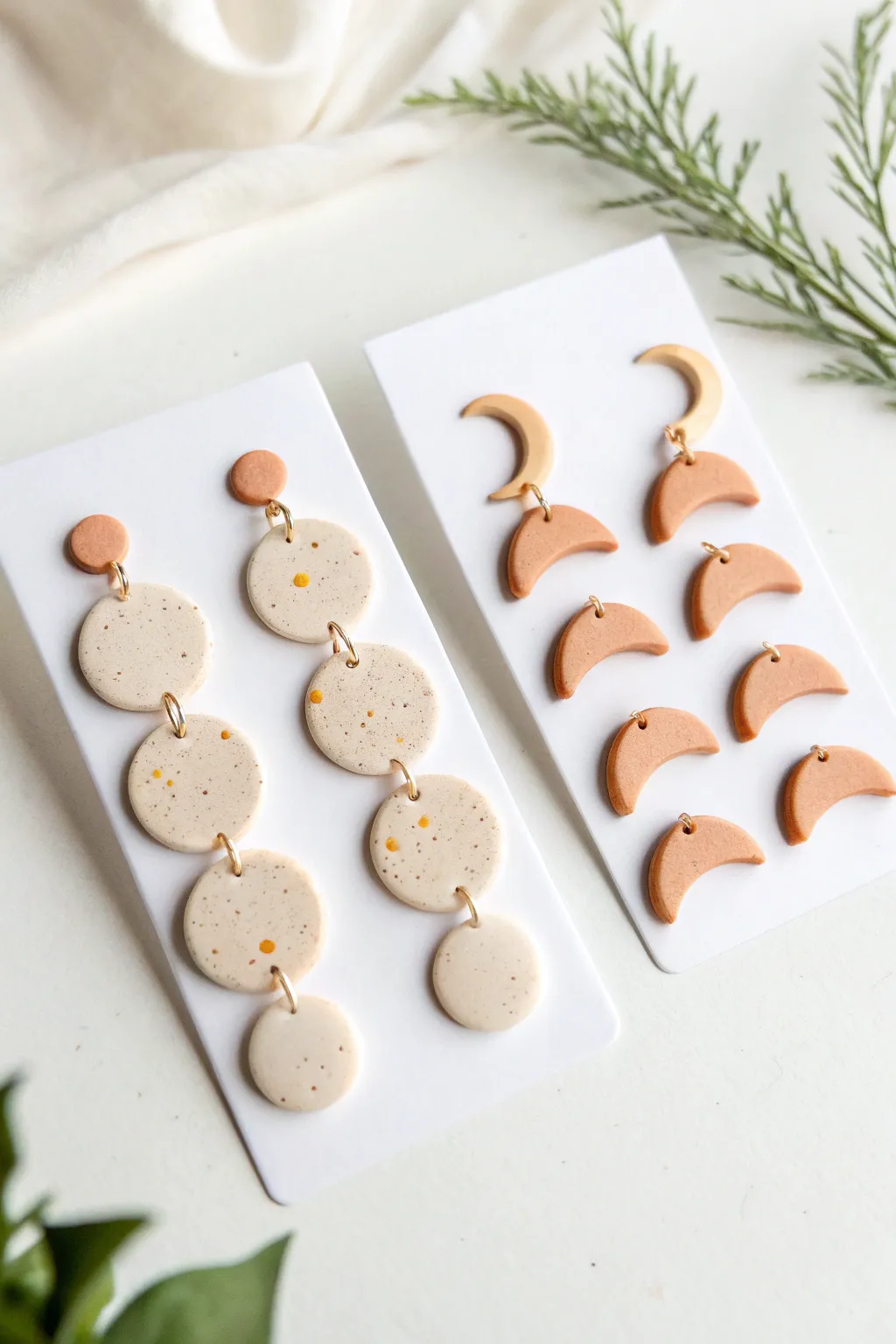 Minimal polymer clay stud trio in moon dot and arch shapes, perfect everyday handmade earrings.
