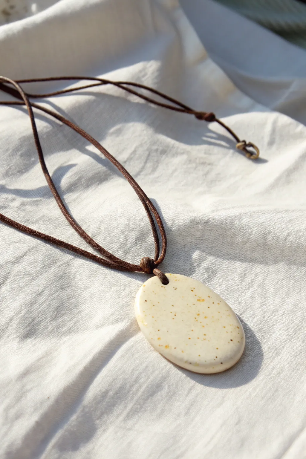 Minimal polymer clay pendant on a cord, effortless Scandinavian calm with a soft boho touch.