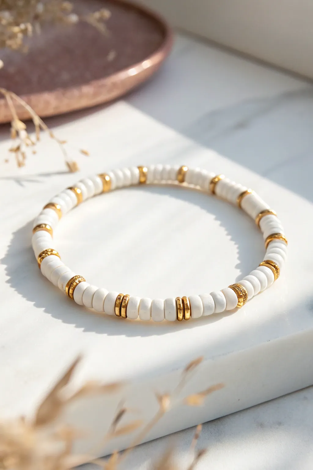 Crisp white heishi beads with gold spacers create a polished, minimal preppy bracelet.