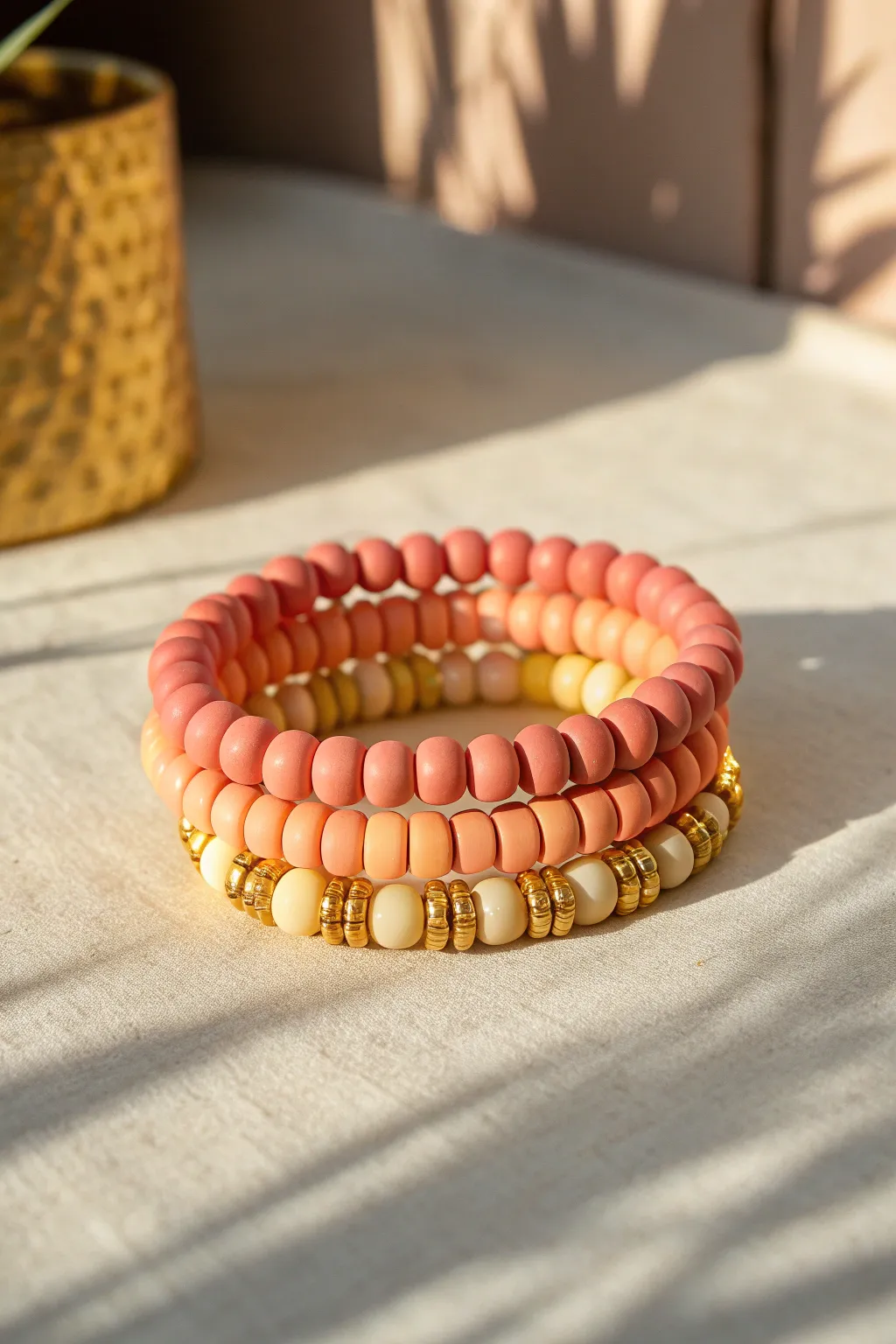 Preppy sunset ombré bracelet stack in coral to peach to buttery yellow with dainty gold spacers