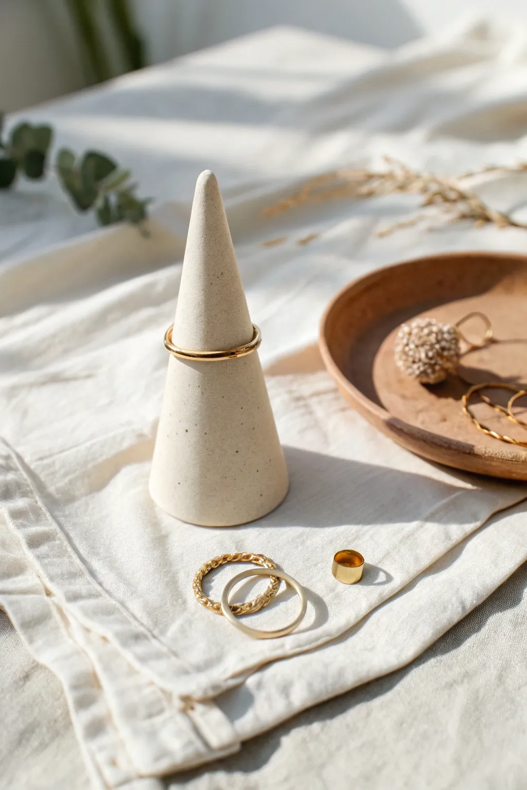 Simple DIY clay ring cone in soft neutrals, styled with rings and a tiny earring dish