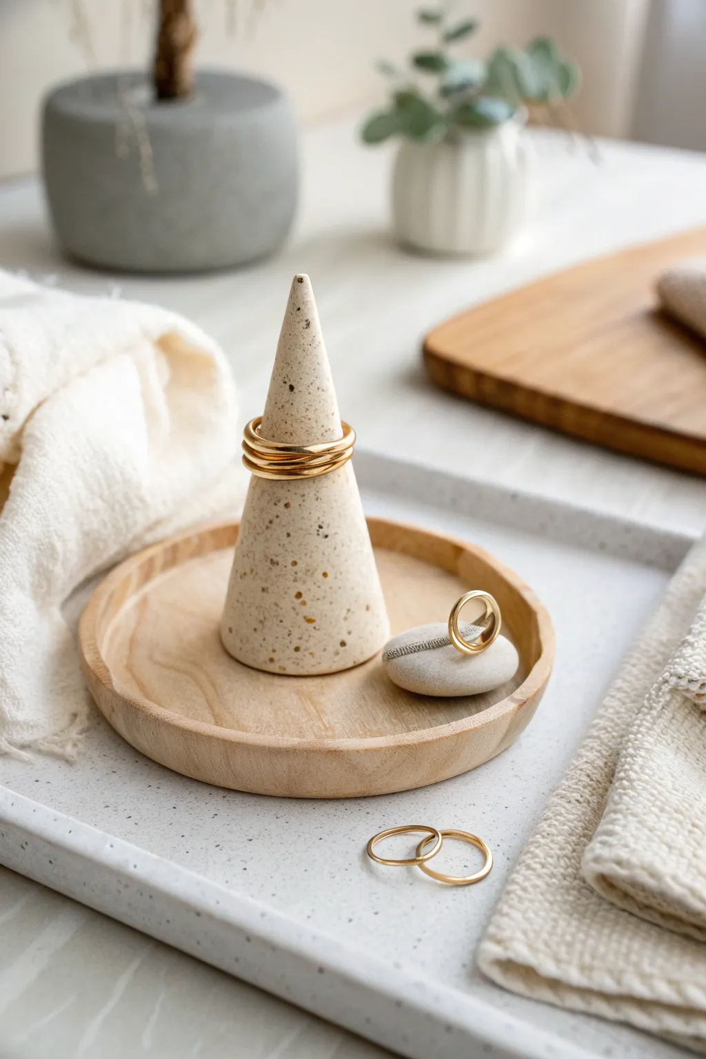 Tiny clay ring cone holder with stacked rings on a clean tray, minimal, cozy, and practical.