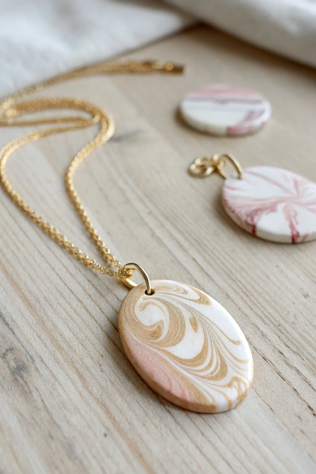 Soft marble-swirled polymer clay pendants in calm boho neutrals, ready to wear and gift.