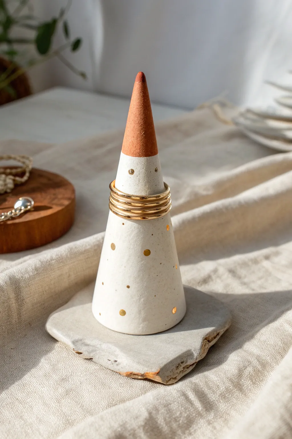 Sleek air-dry clay ring cone stand with dipped tip and tiny dots, a chic DIY birthday gift.