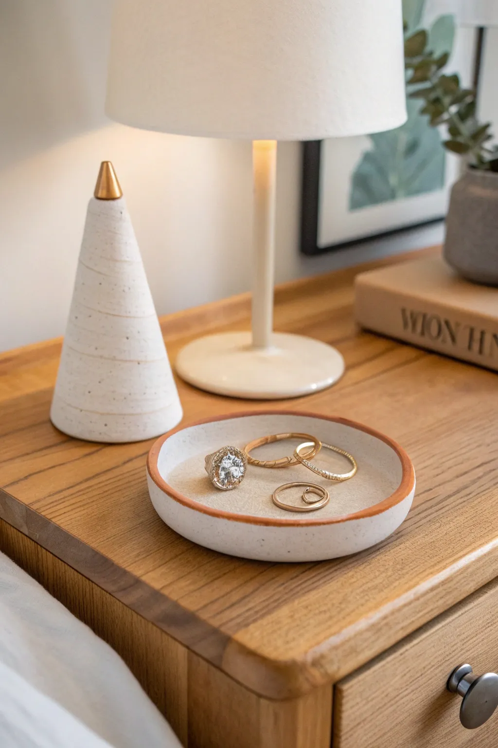 Minimal air dry clay ring cone and tray set styled by a warm bedside lamp, calm and modern