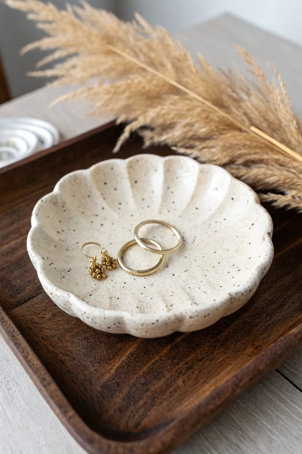 Scalloped air dry clay dish in a minimalist style, ideal for tiny earrings and daily treasures