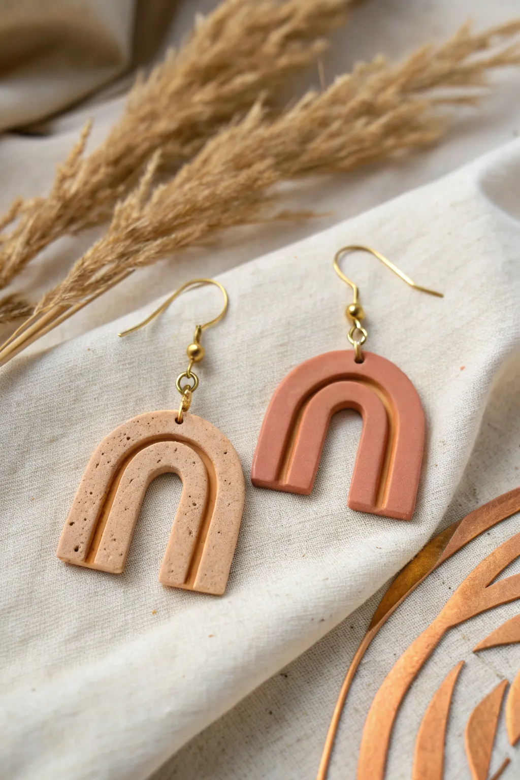 Modern arch air-dry clay earrings in warm neutrals, matte finish, minimalist boho styling.