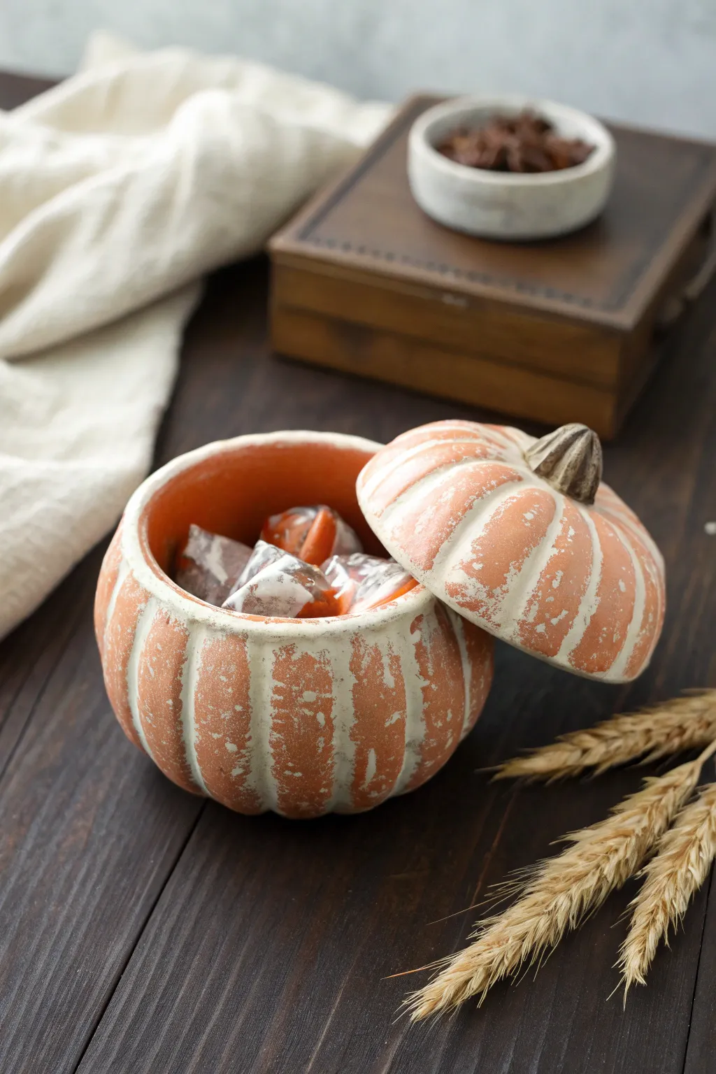 Air-dry clay mini pumpkin pinch-pot bowl, a minimalist Thanksgiving accent with hidden candy