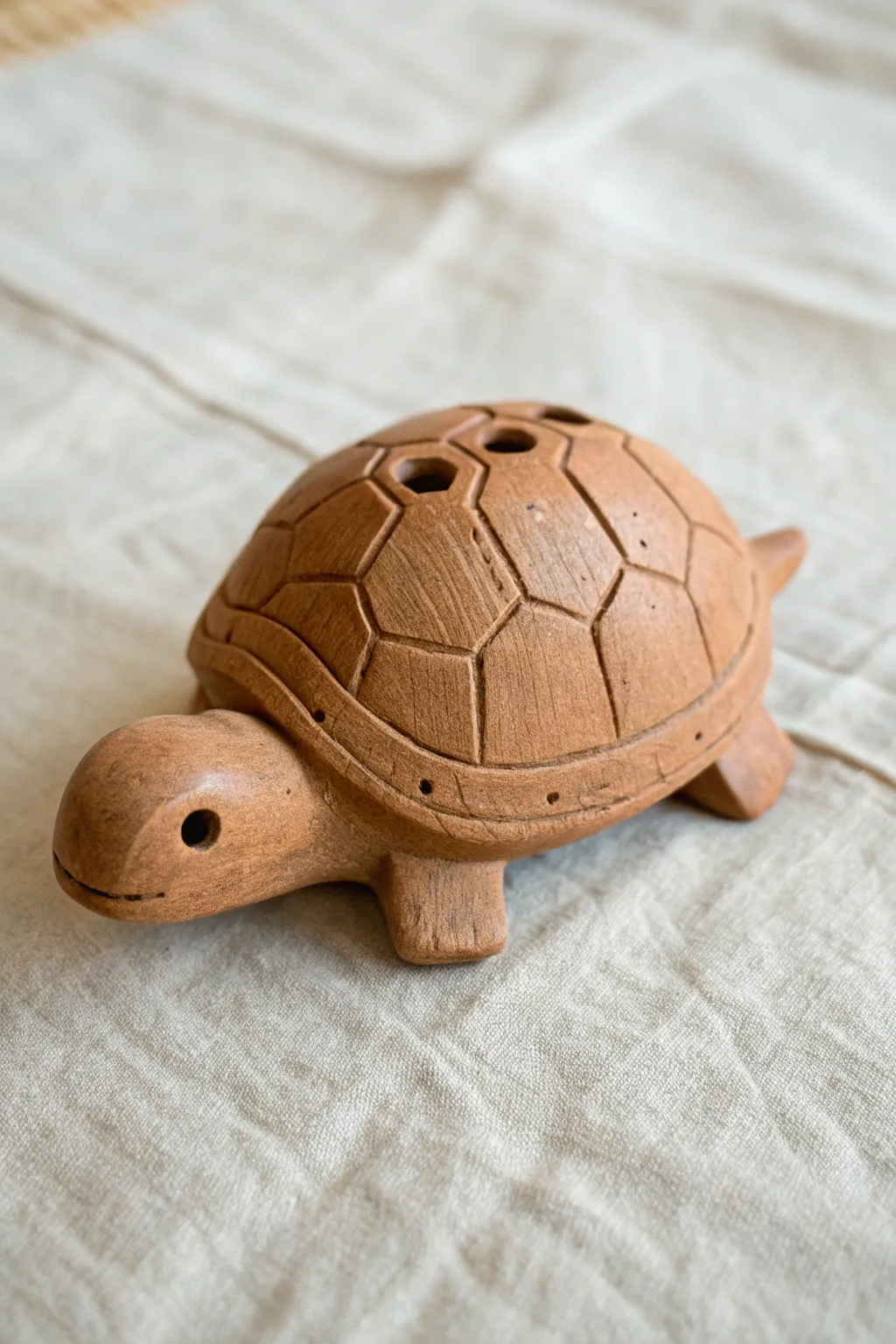 Minimal turtle shell clay whistle with a hidden window and tail mouthpiece, calm boho beauty.