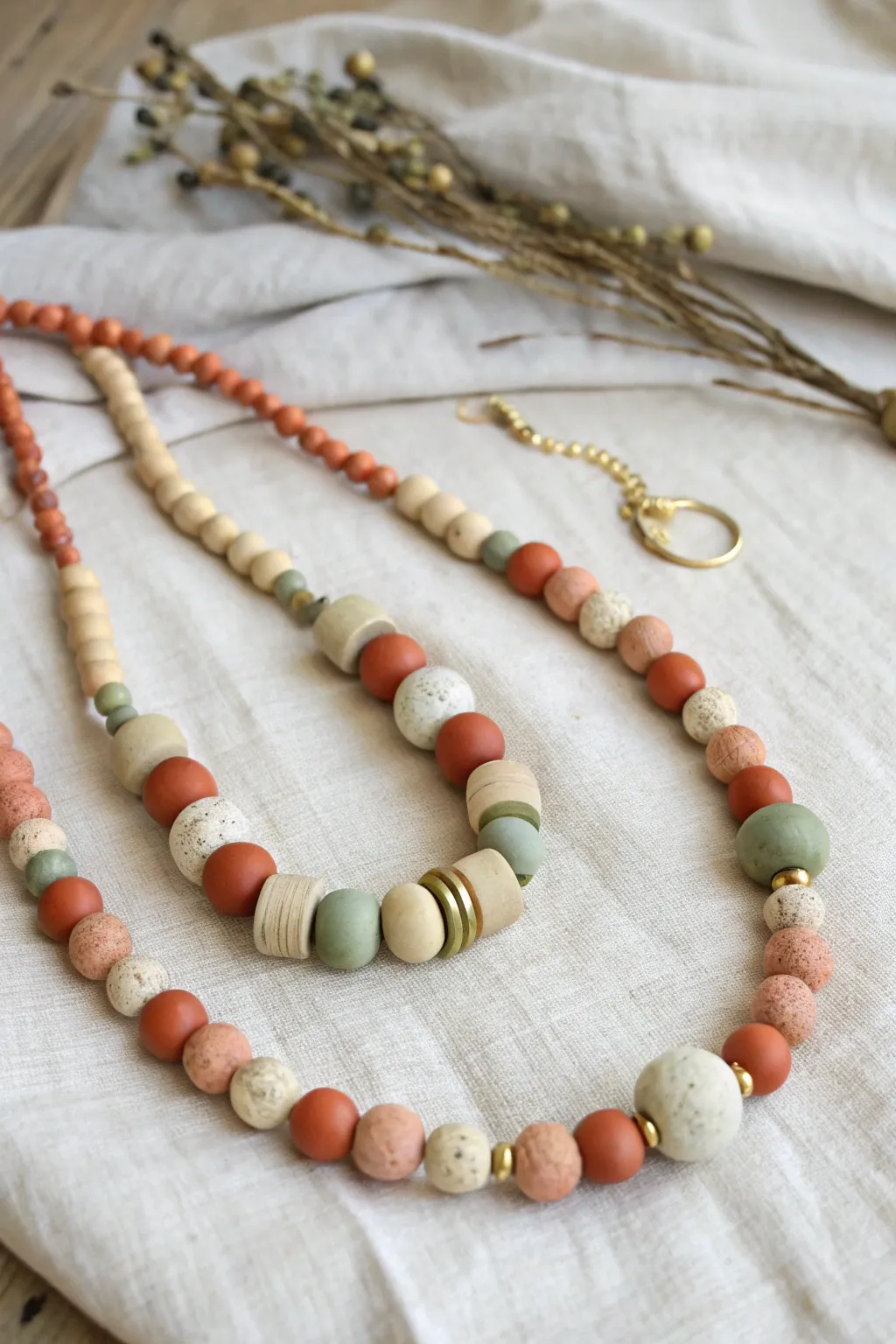 Chunky bakeable clay bead necklace on linen, simple clasp, soft Scandinavian boho vibe.