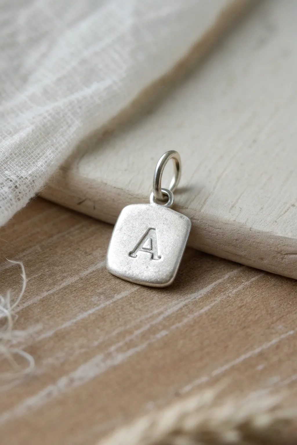 Minimal silver clay initial tag charm with jump ring, handmade look, simple and ready to wear