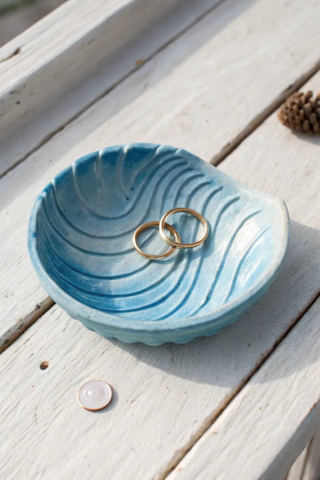 Ocean wave trinket dish in blue air dry clay, a minimalist catchall for rings and coins.