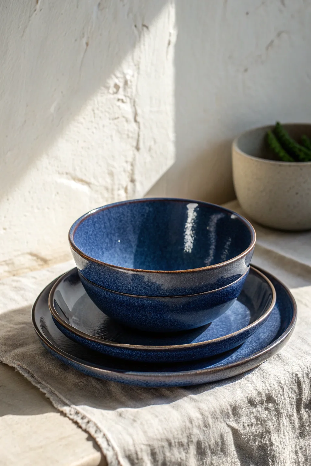 Deep indigo soup bowl with a bold foot ring, stacked simply for a calm minimalist look