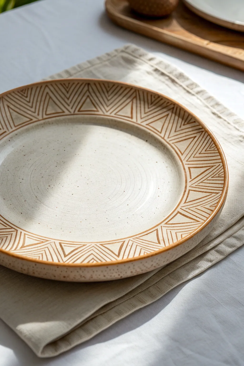 Slab-built plate with a bold sgraffito rim, minimal and modern with soft boho warmth.