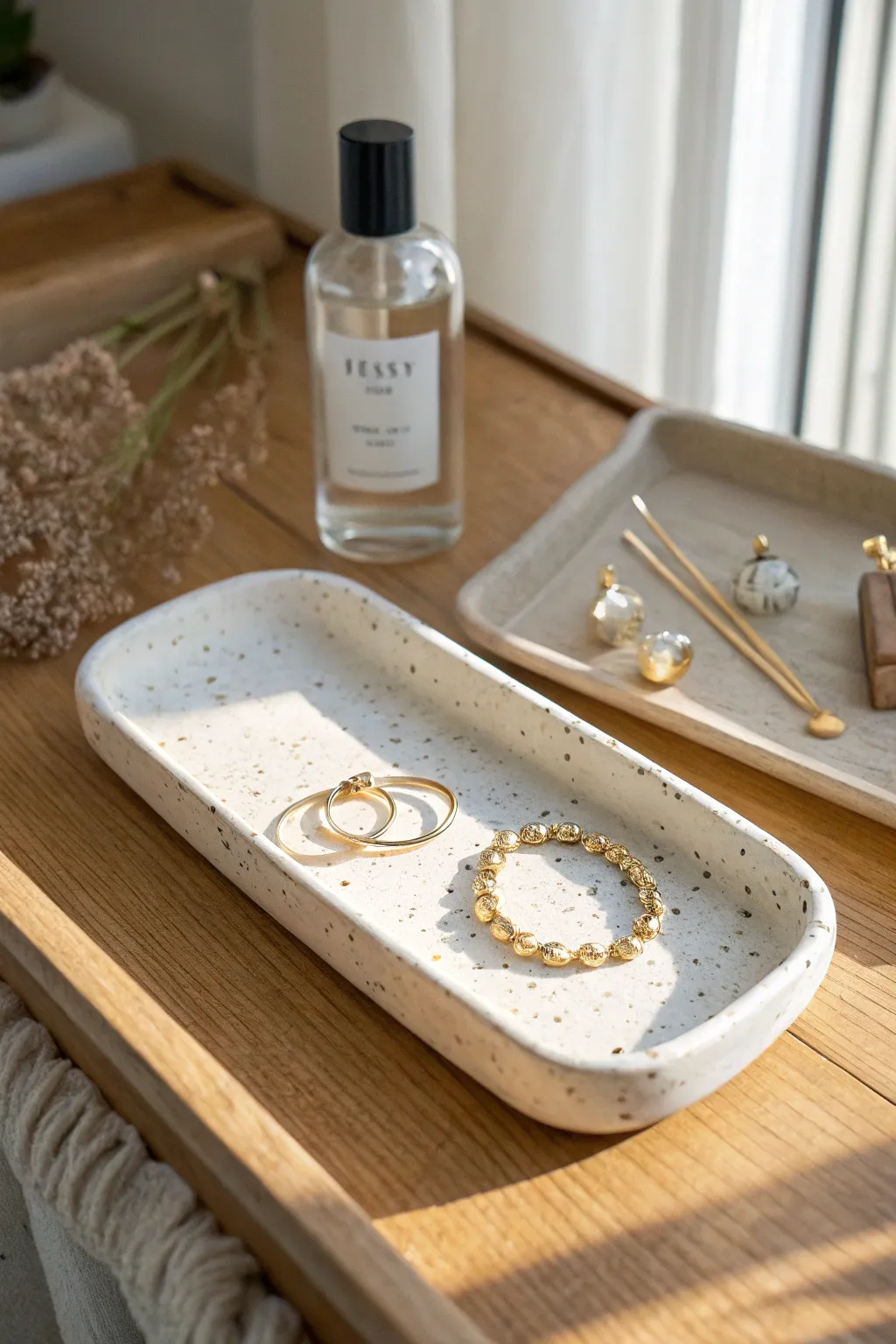 Long minimalist ceramic vanity tray styling idea with perfume, clip, and jewelry accents