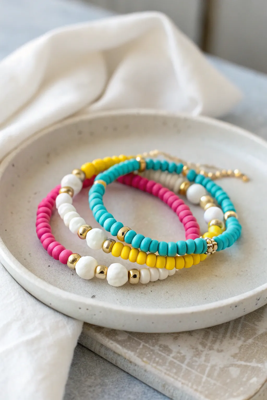 Hot pink, turquoise, sunny yellow and crisp white make a preppy clay bead bracelet stack.