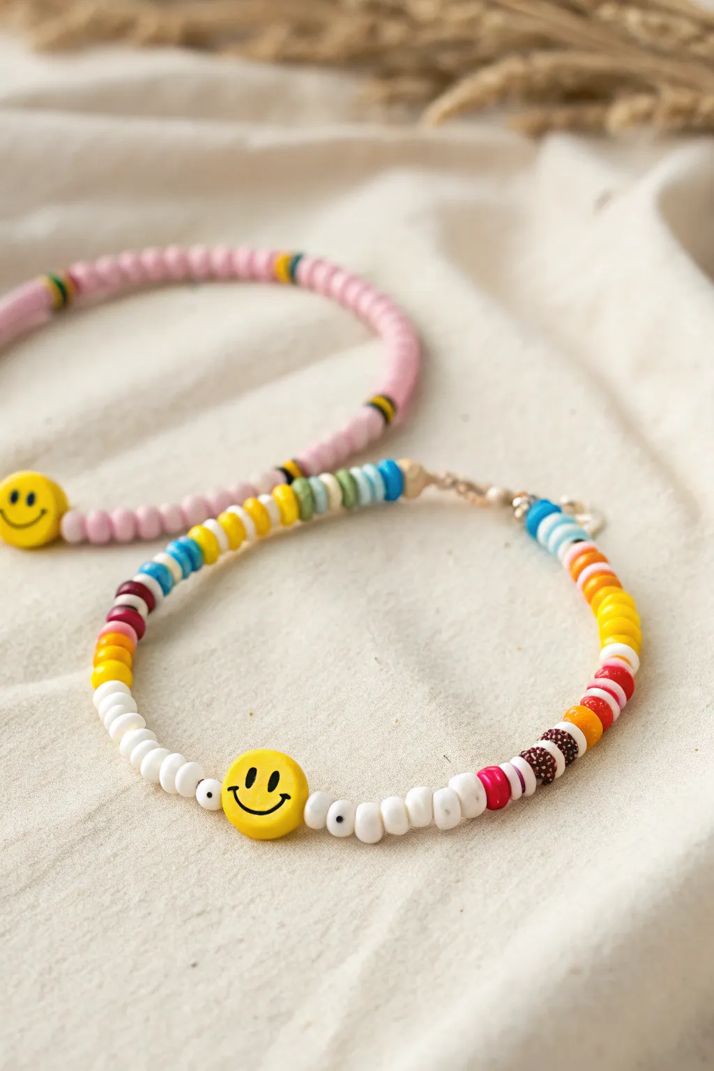 Rainbow heishi clay beads with a smiley pop, minimalist stack for sunny boho vibes.