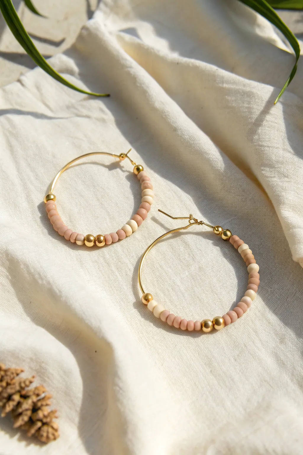 Minimal clay bead hoops with a gold spacer bead center accent, clean symmetry and soft boho warmth.