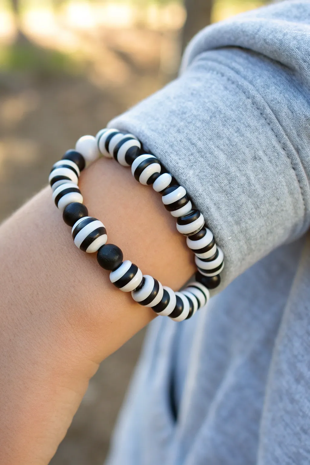 Two-color sport stripe clay bead bracelet idea for boys, clean and modern with handmade charm