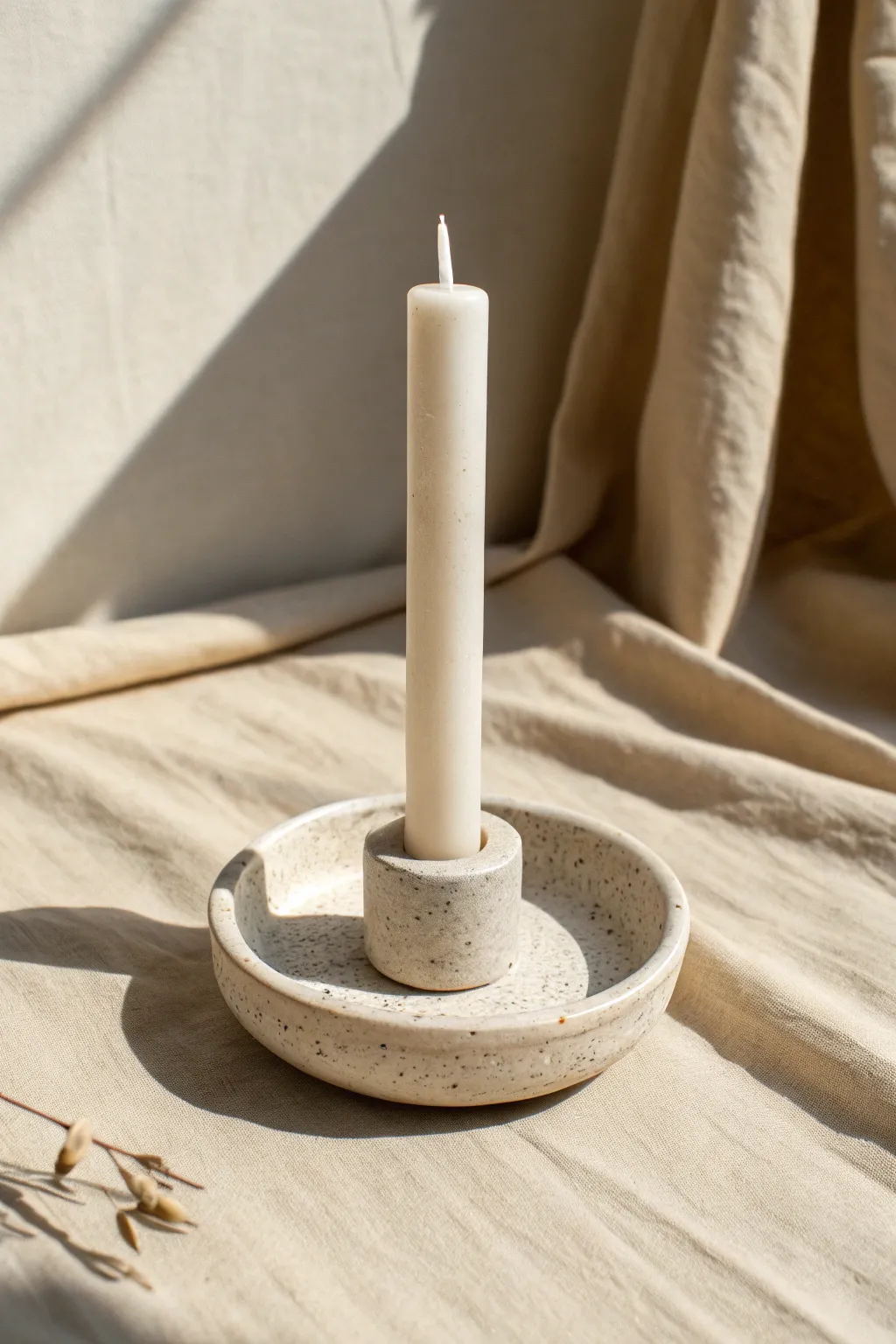 A simple clay taper candle socket with a wide base and clean silhouette, calm and modern