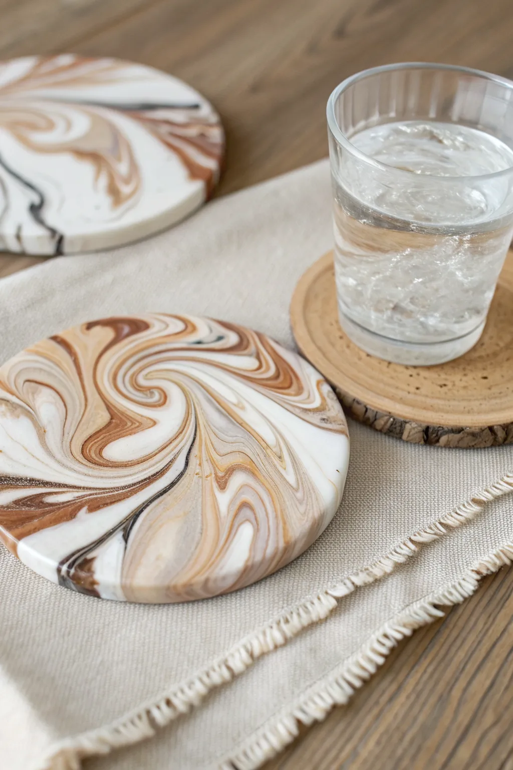 Classic faux marble swirl coasters in soft neutrals, minimal styling, and a fresh condensation touch.