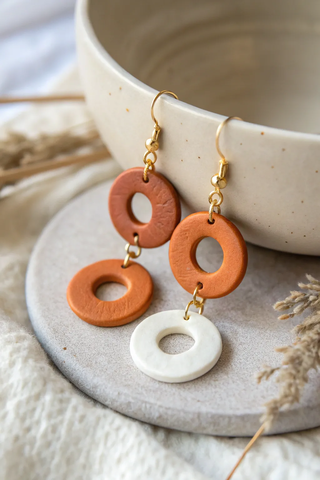 Two-tier circle drop clay earrings in terracotta and off-white, simple, modern, and handmade.