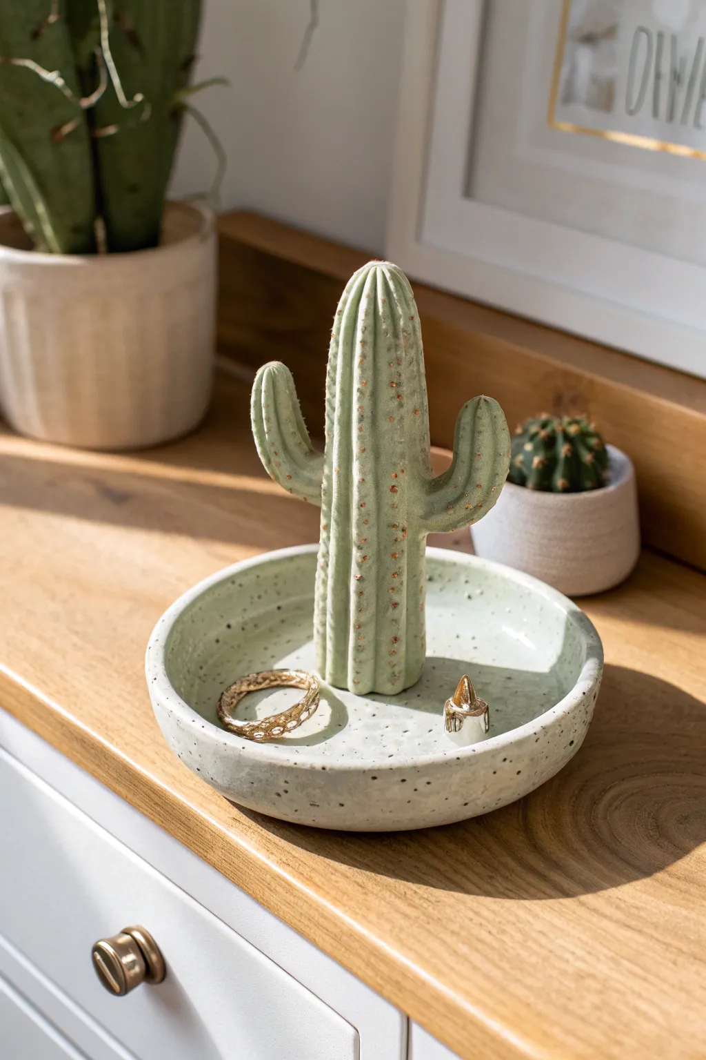 Earthy ceramic cactus ring holder with two arms and a base dish for a calm vanity moment