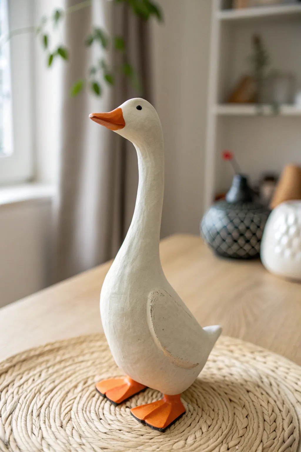 A sweet minimalist white clay goose buddy with bright orange feet in calm farmhouse neutrals.