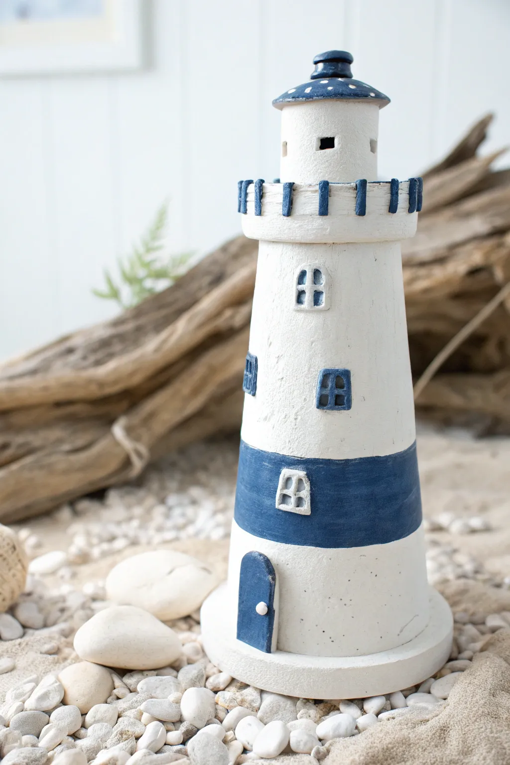 Blue and white striped clay pot lighthouse, clean coastal charm for a minimalist boho home