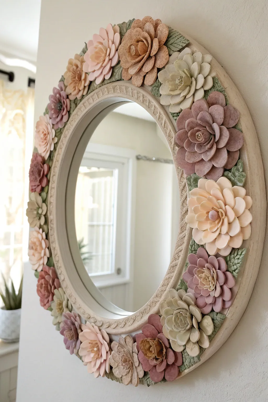 Soft pastel clay blossoms transform a simple mirror into a full garden frame, airy and handmade.