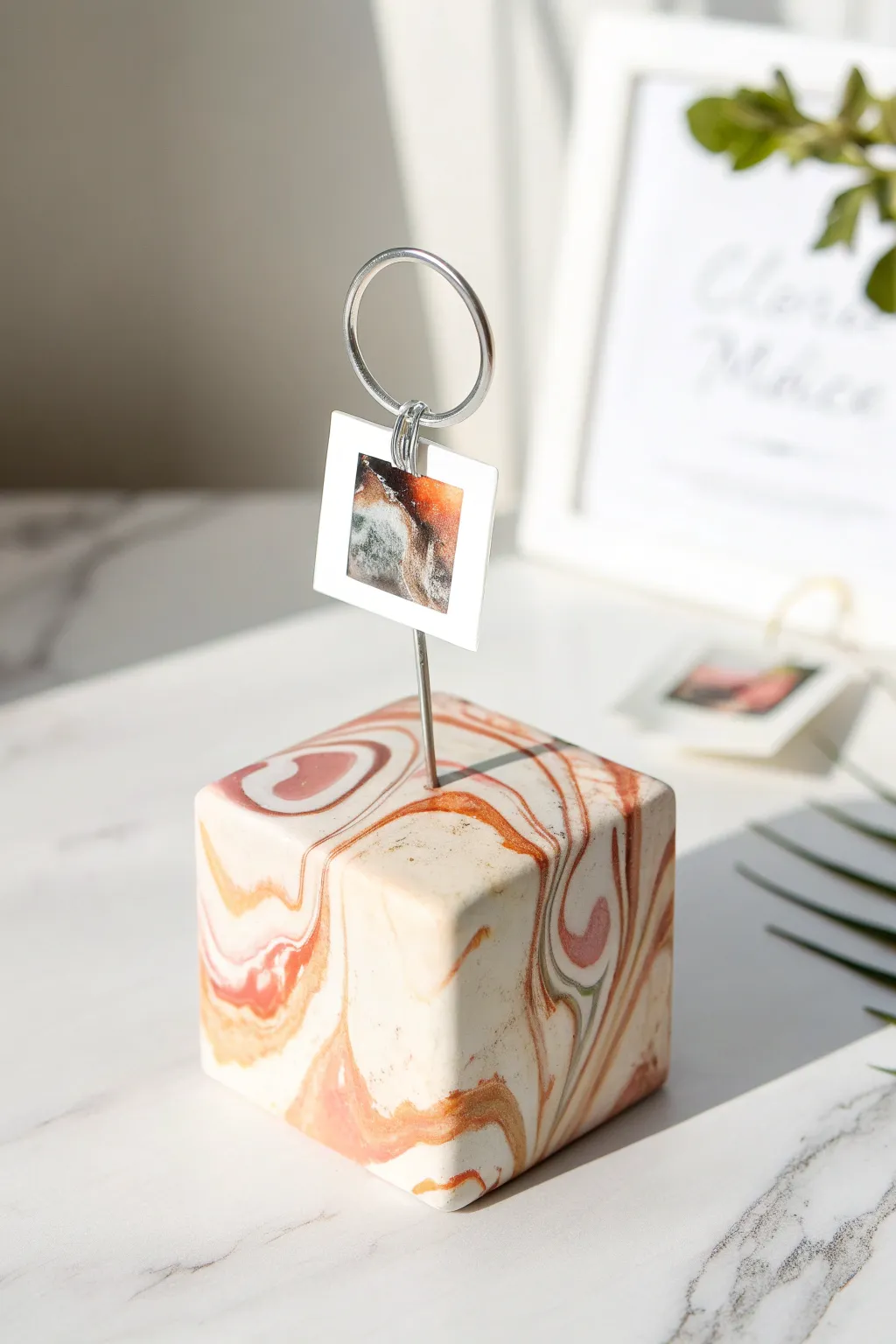 Marbled clay cube photo holder with a simple wire clip, minimal Scandinavian charm for your desk.