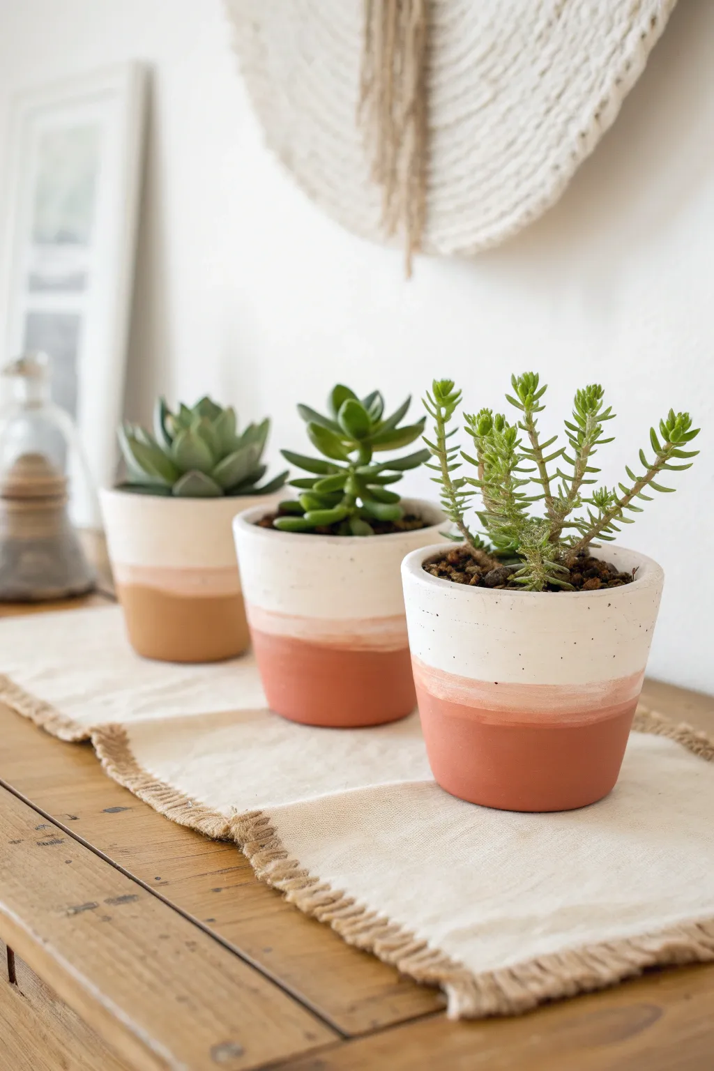 Soft ombre painted clay pots with simple succulents for an easy, modern boho windowsill.