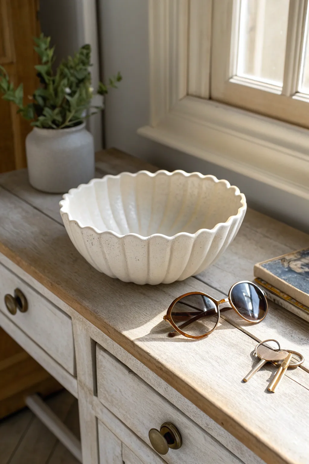 Matte scalloped trinket bowl keeps keys and sunnies tidy with calm minimalist charm.