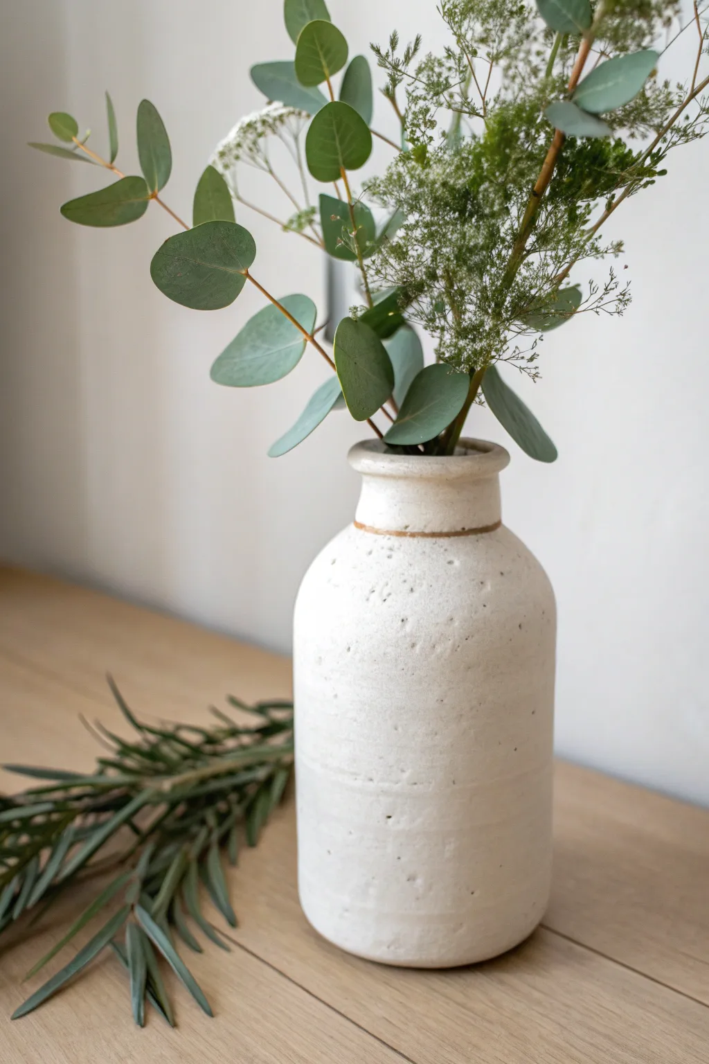 Air-dry clay–wrapped jar vase with fresh greenery, a simple upcycled design that feels calm and modern.